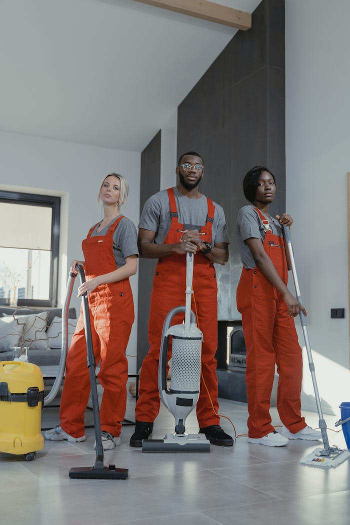 hero-img Three cleaners in uniform with equipment in a modern home interior, showcasing teamwork and professionalism.